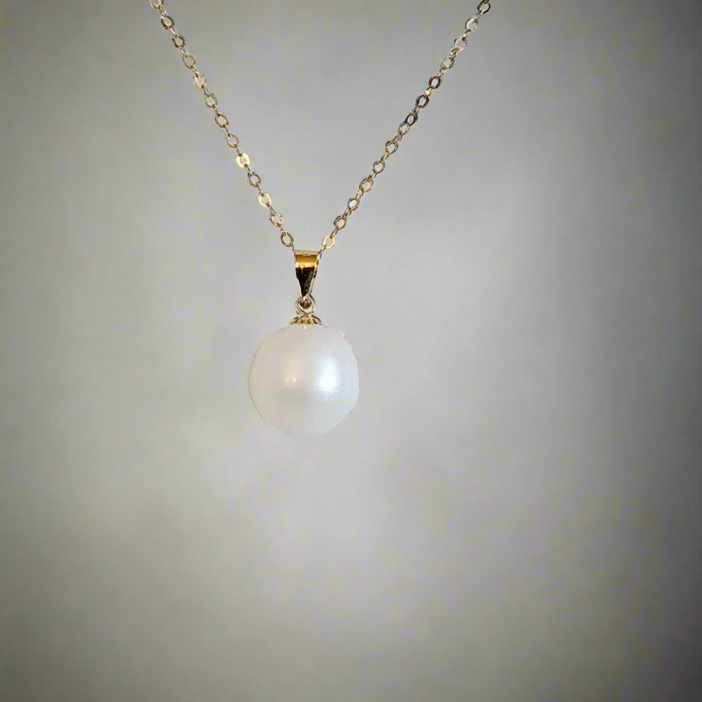 pearl hanging down on a neutral background