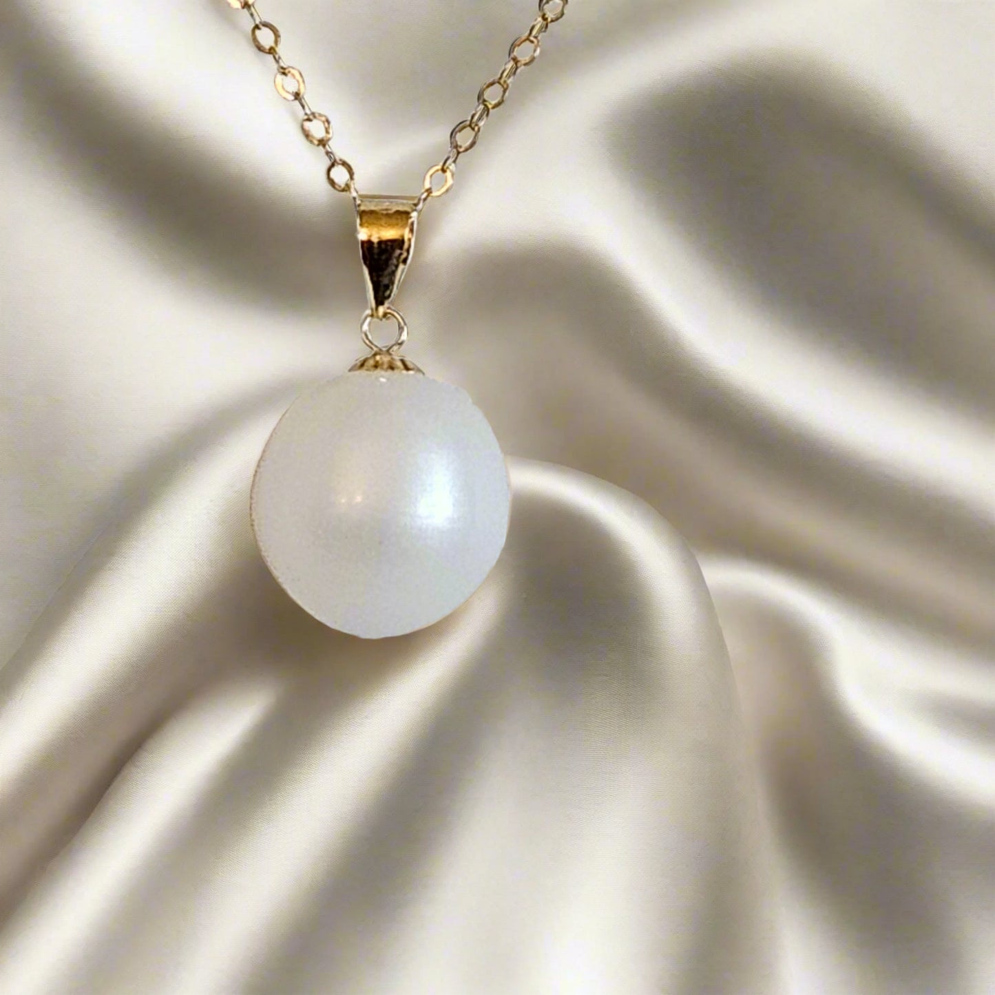 close up of a waterdrop pearl on silk