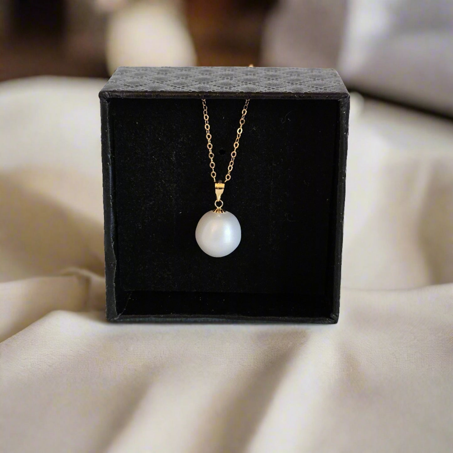 pearl in gift box on a table
